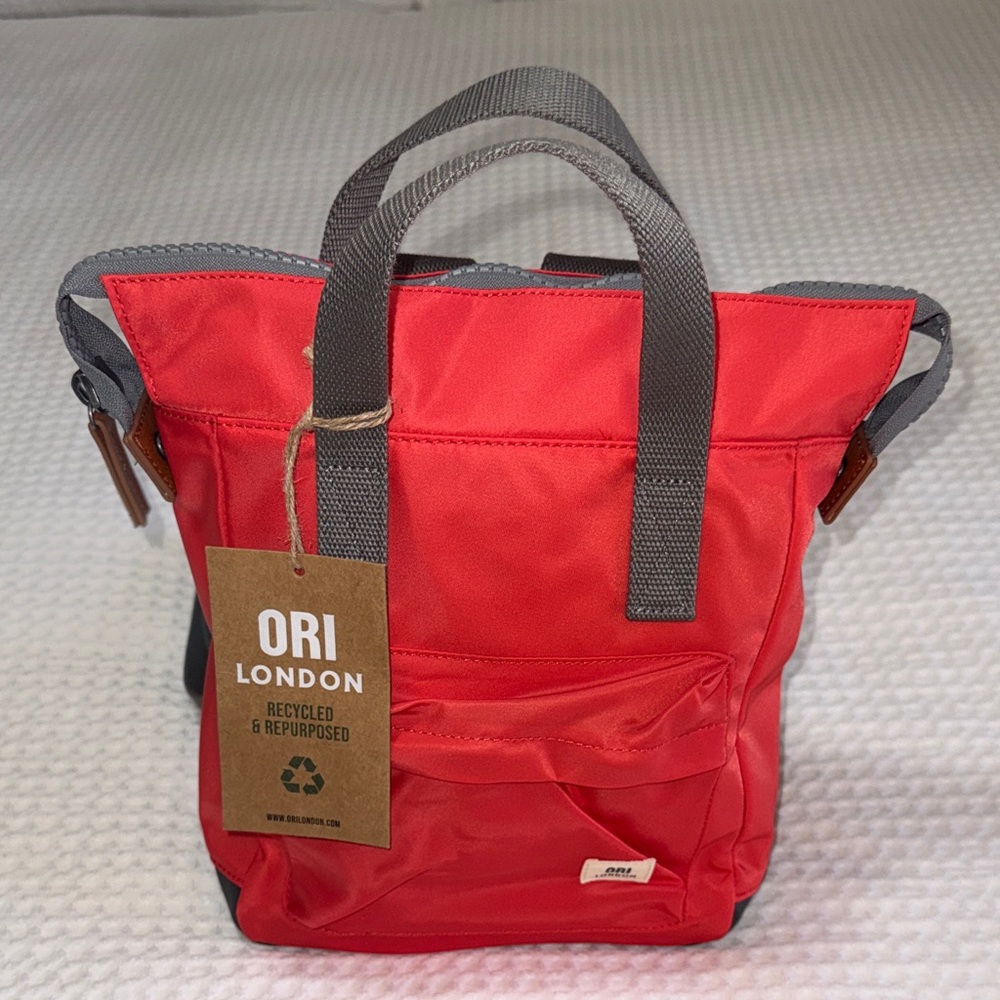 ORI LONDON Backpack; color is poppy.